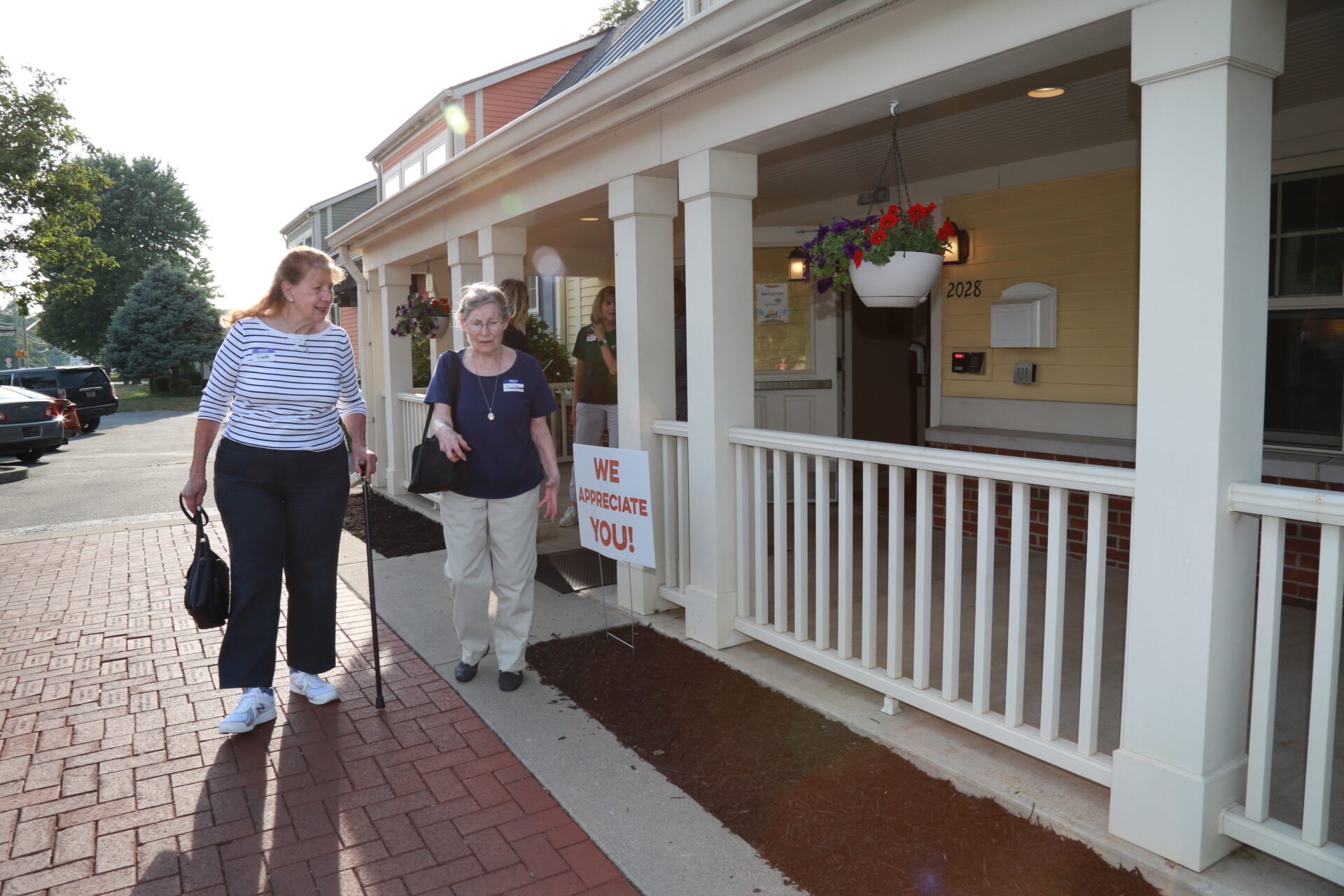 Two ladies walking out of Joy's House