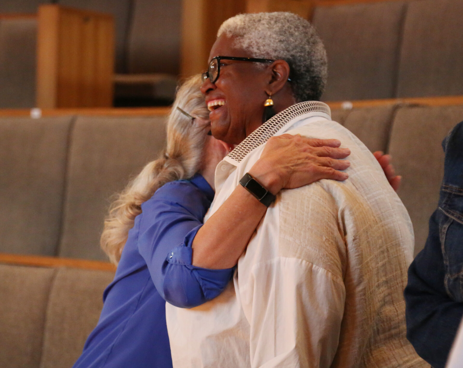 caregiver hugging Joy's House donor