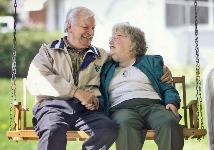 Elderly couple on porch swing at Joy's House